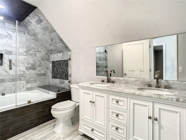 full bathroom with vanity, vaulted ceiling, bath / shower combo with glass door, and toilet