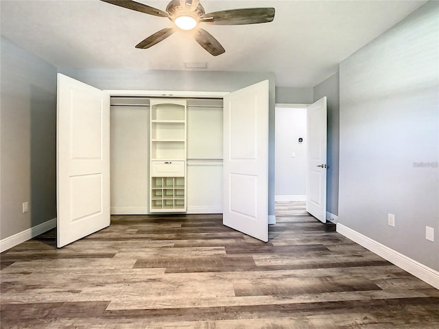 unfurnished bedroom featuring dark wood-type flooring, ceiling fan, and a closet