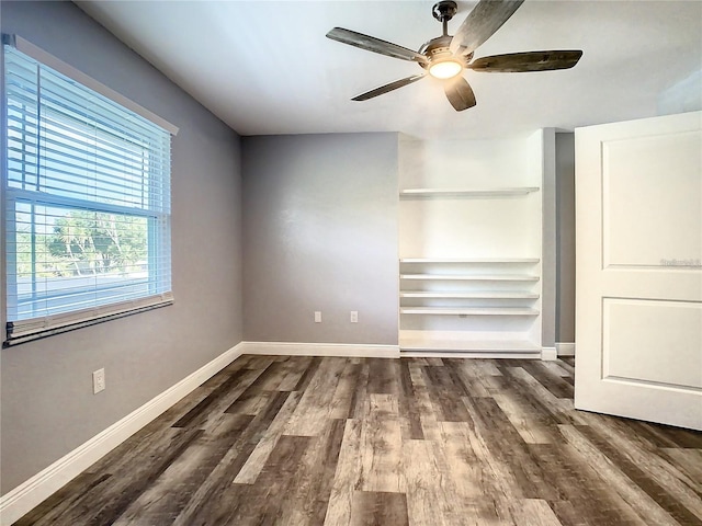 unfurnished bedroom featuring ceiling fan and dark hardwood / wood-style flooring