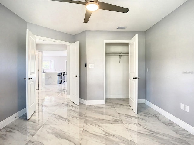 unfurnished bedroom featuring ceiling fan and a closet