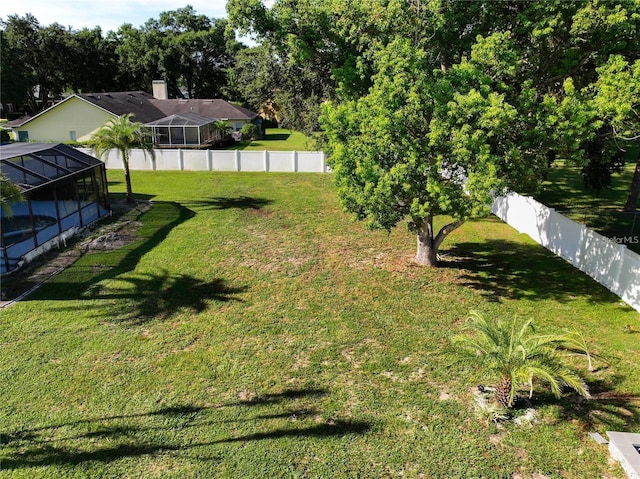 view of yard featuring glass enclosure