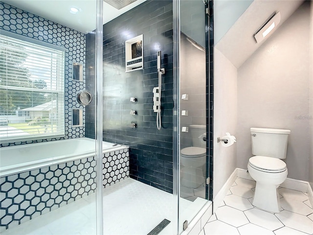 bathroom with tile patterned flooring, shower with separate bathtub, and toilet
