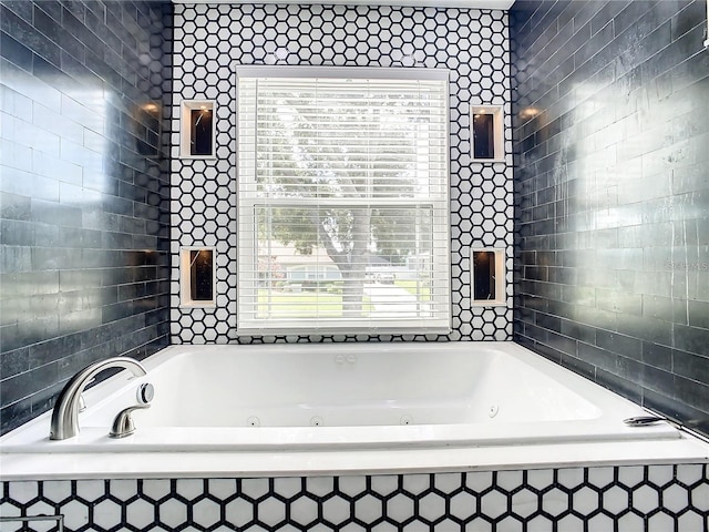 bathroom with a relaxing tiled tub and tile walls