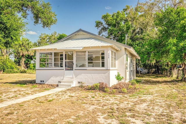 bungalow featuring a sunroom