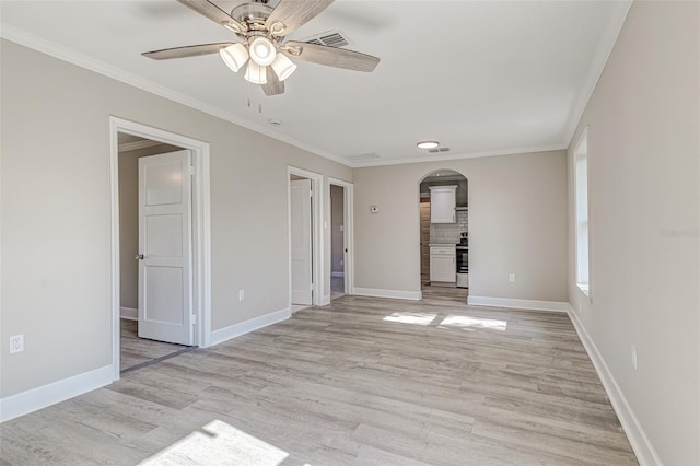 empty room with ceiling fan, light hardwood / wood-style floors, and crown molding