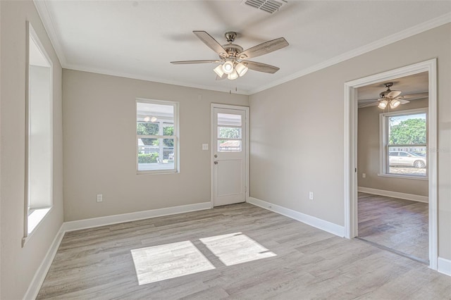 spare room with ceiling fan, light hardwood / wood-style floors, and crown molding