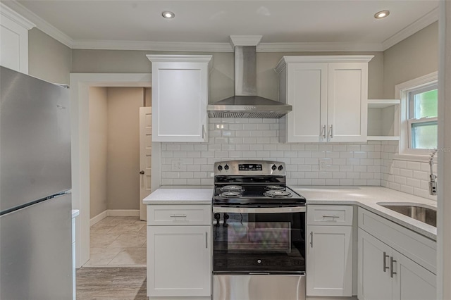 kitchen featuring decorative backsplash, stainless steel appliances, crown molding, wall chimney range hood, and white cabinets