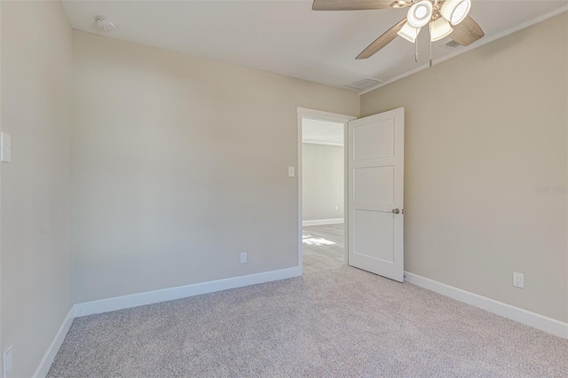 carpeted spare room featuring ceiling fan