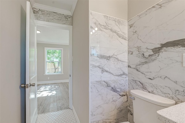 bathroom with toilet, tile walls, and ornamental molding