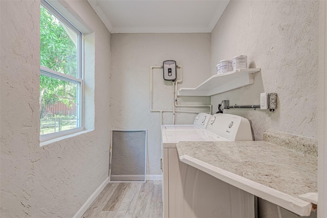 clothes washing area with hardwood / wood-style flooring, separate washer and dryer, and ornamental molding