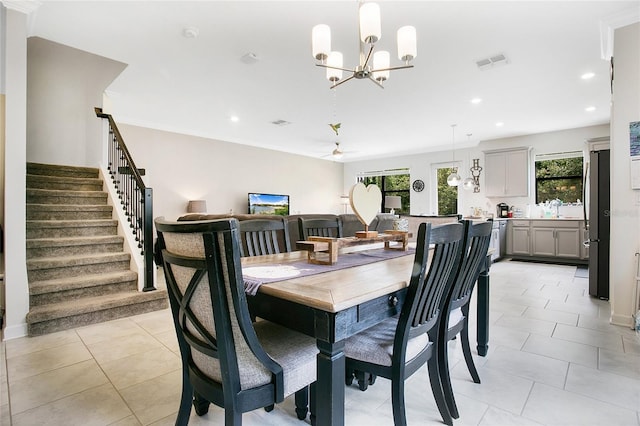 dining space featuring a wealth of natural light, ornamental molding, and light tile patterned flooring