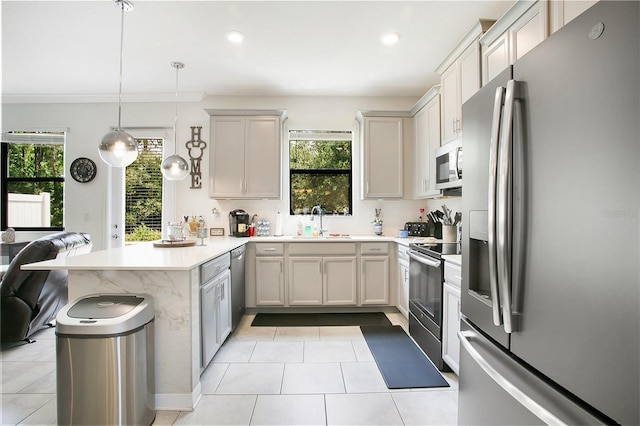 kitchen with pendant lighting, sink, ornamental molding, appliances with stainless steel finishes, and kitchen peninsula