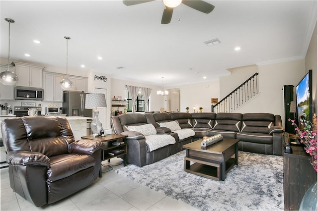 living room featuring light tile patterned floors, ceiling fan with notable chandelier, and ornamental molding