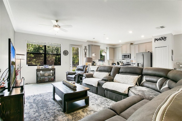 living room featuring ceiling fan, crown molding, and light tile patterned floors