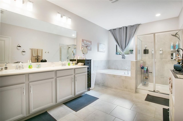 bathroom with tile patterned floors, vanity, and independent shower and bath