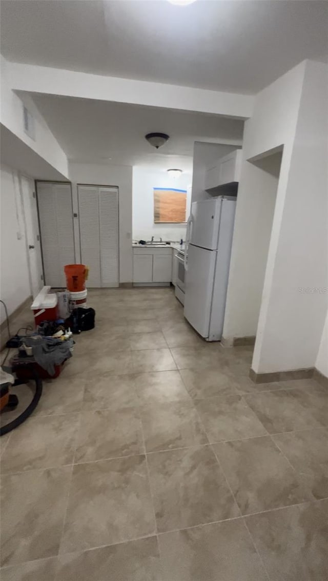 kitchen with range, white fridge, and sink