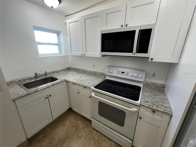 kitchen with sink, light stone countertops, light tile patterned floors, white electric range oven, and white cabinetry