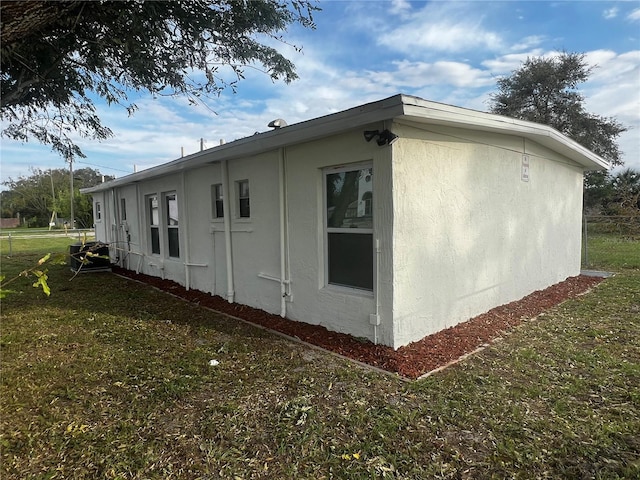 view of side of home featuring a yard