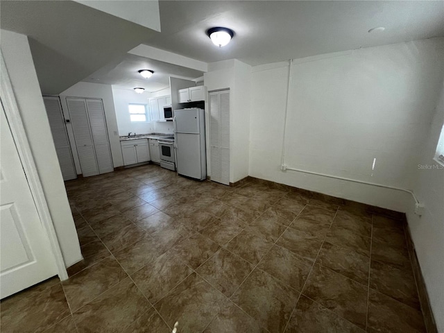 kitchen with white cabinets, white refrigerator, stove, and sink