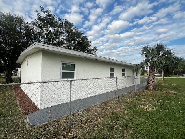 view of home's exterior with a lawn