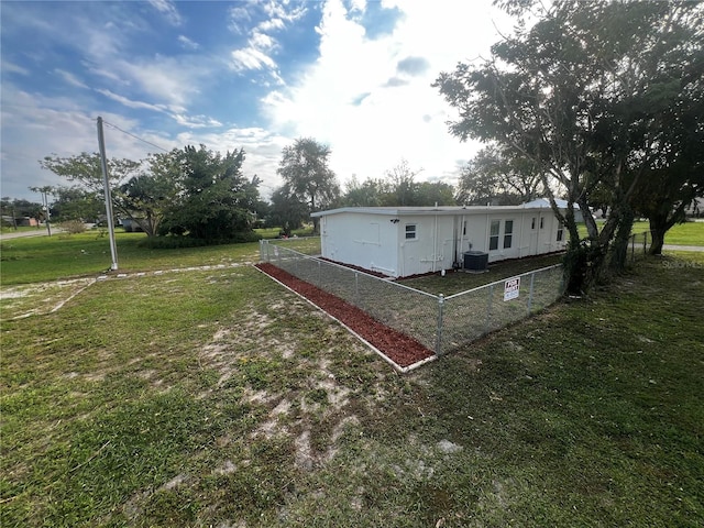 exterior space with a lawn and central AC