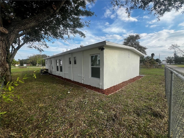 view of side of property with a lawn