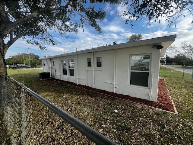 view of home's exterior featuring a lawn and cooling unit