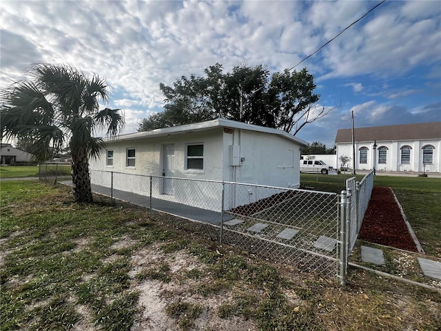 view of side of home with a yard