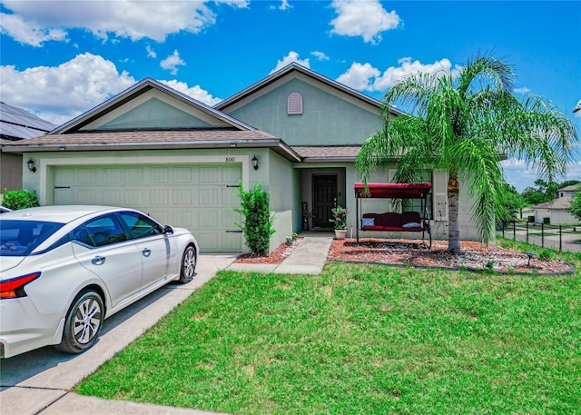 ranch-style house featuring a garage and a front lawn