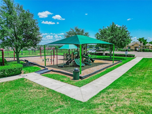 view of playground with a lawn