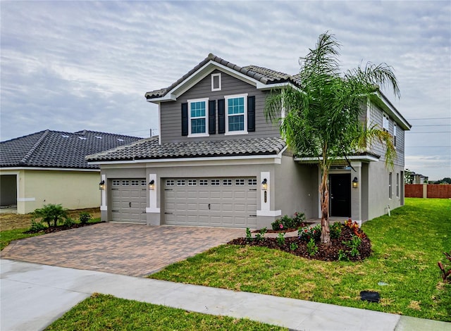 view of front of home featuring a front yard and a garage