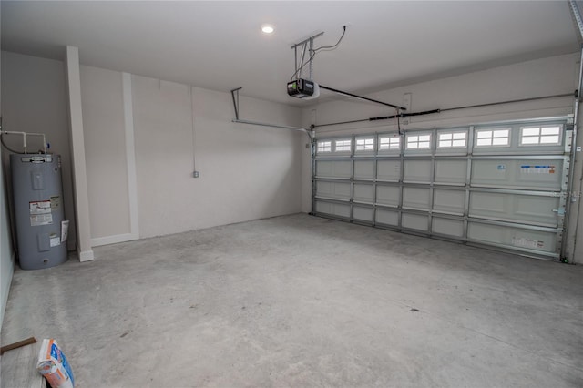 garage featuring a garage door opener and electric water heater