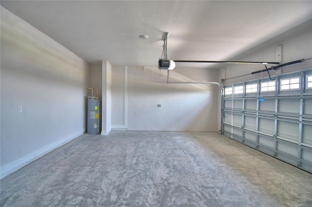 garage featuring electric water heater and a garage door opener