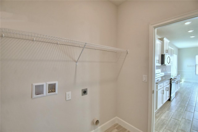 laundry area with baseboards, washer hookup, hookup for an electric dryer, and laundry area