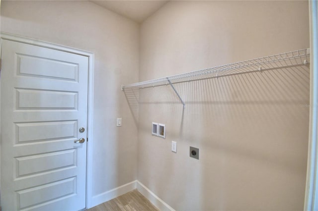 laundry room featuring hookup for an electric dryer, light wood-type flooring, hookup for a washing machine, baseboards, and laundry area