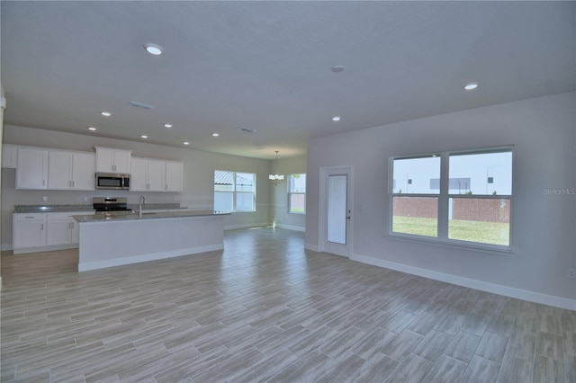 kitchen with visible vents, recessed lighting, appliances with stainless steel finishes, a sink, and open floor plan