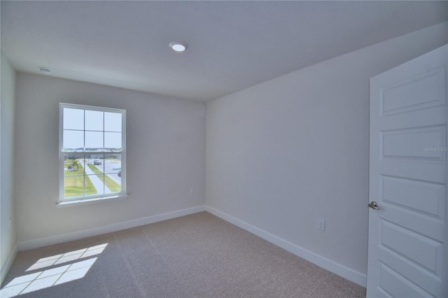 empty room with carpet floors and baseboards