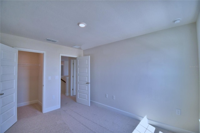 unfurnished bedroom with baseboards, visible vents, a closet, and carpet