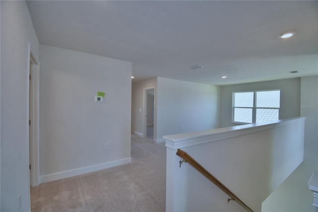 unfurnished room featuring baseboards, light colored carpet, and recessed lighting