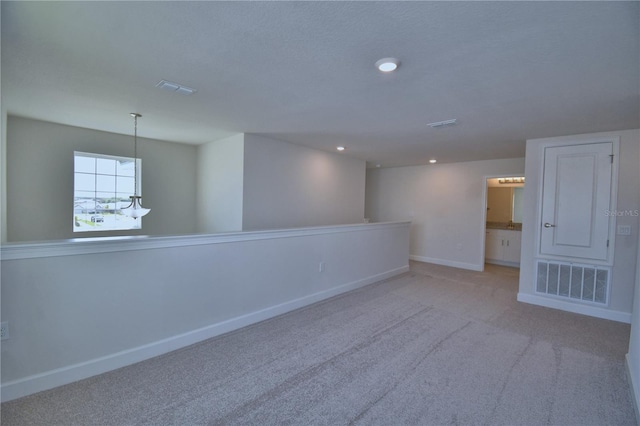 unfurnished room with baseboards, visible vents, recessed lighting, and carpet flooring