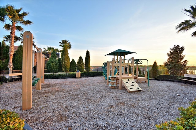 playground at dusk with playground community and fence