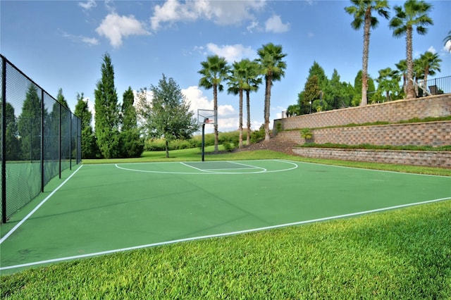 view of basketball court with community basketball court and fence