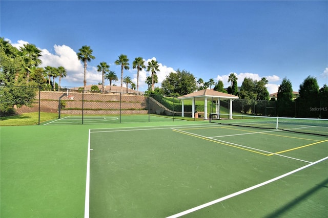 view of tennis court featuring fence