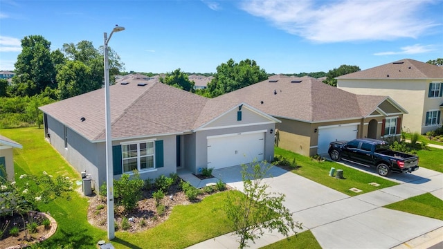 ranch-style home featuring a front yard and a garage