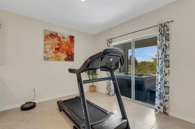 workout area with baseboards and tile patterned floors