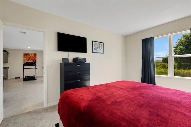 bedroom with light carpet, light tile patterned floors, visible vents, and baseboards