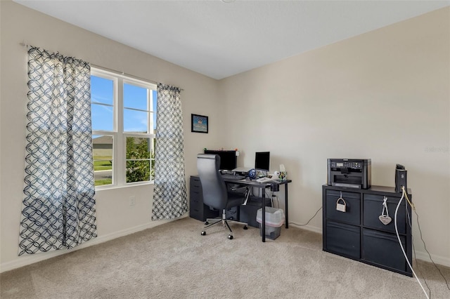 carpeted office featuring baseboards