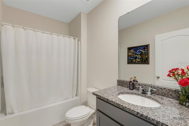 bathroom featuring toilet, shower / tub combo, and vanity