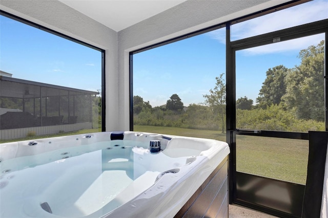 sunroom with a hot tub