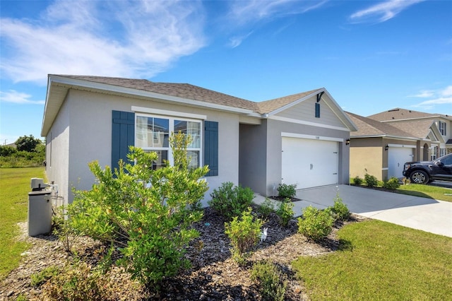 ranch-style home with a front yard, concrete driveway, an attached garage, and stucco siding